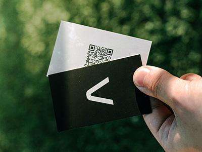 Person holding black and white business cards